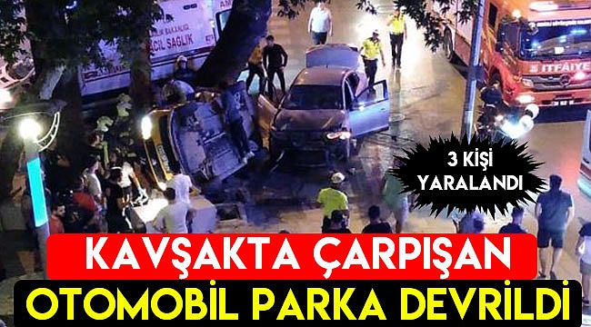 Kavşakta çarpışan otomobil parka devrildi