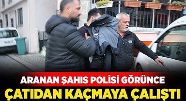 Aranan şahıs polisi görünce çatıdan kaçmaya çalıştı